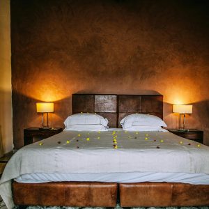 Inviting bedroom setting with plush bedding and ambient lighting for a relaxing atmosphere.